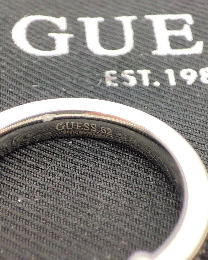 Close-up of engraved Guess logo inside silver steel ring
