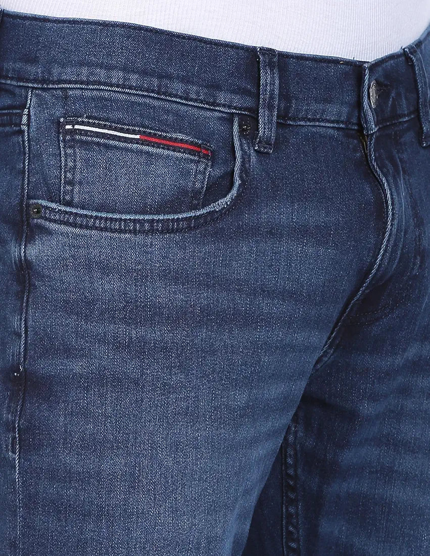 Close-up of Tommy Jeans faded denim front pocket with flag tab