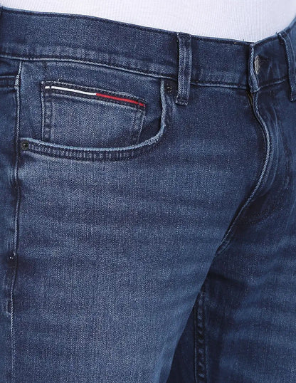 Close-up of Tommy Jeans faded denim front pocket with flag tab