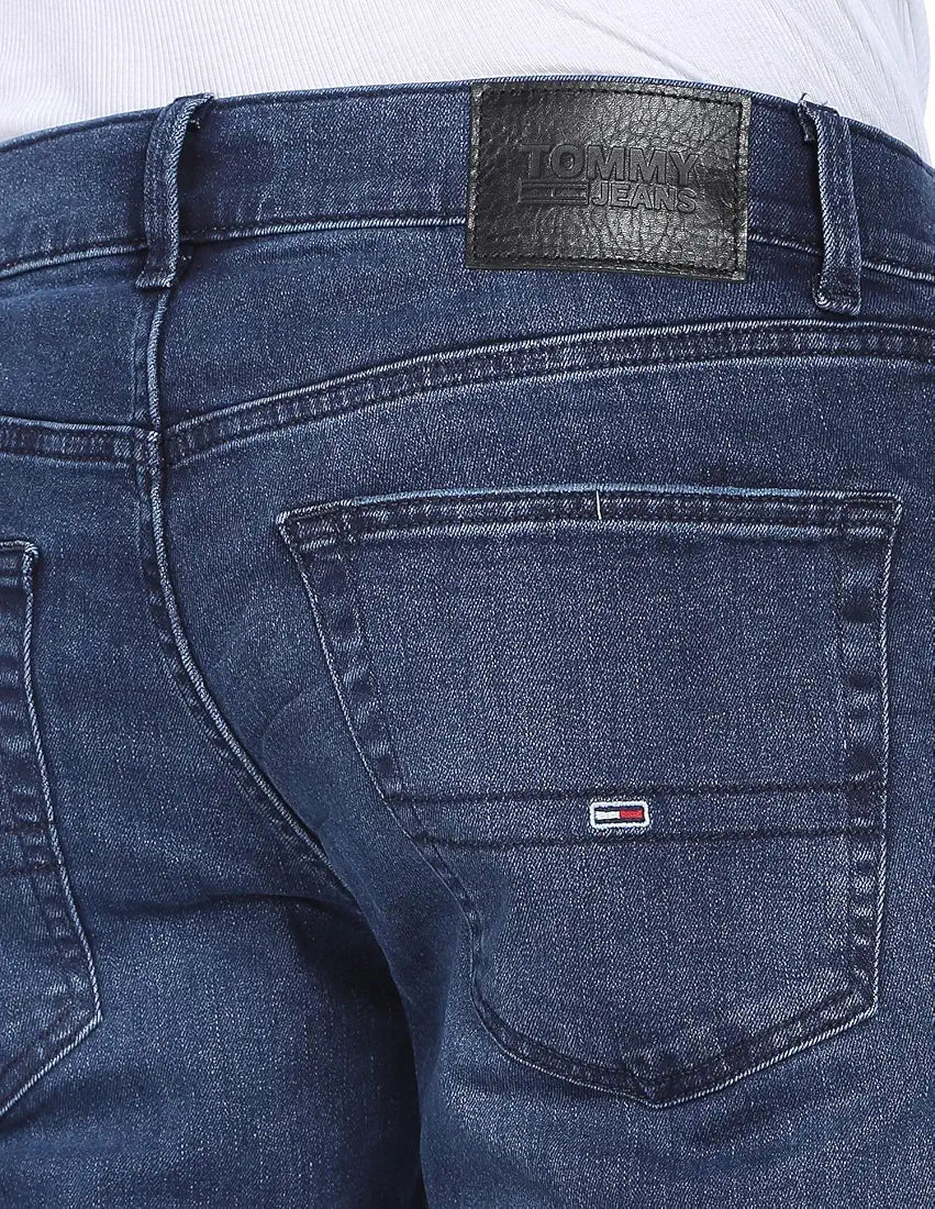 Close-up of Tommy Jeans faded denim back pocket and leather patch