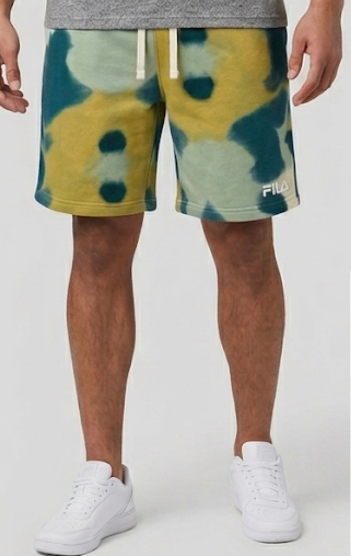 Man wearing Fila camo print shorts, front