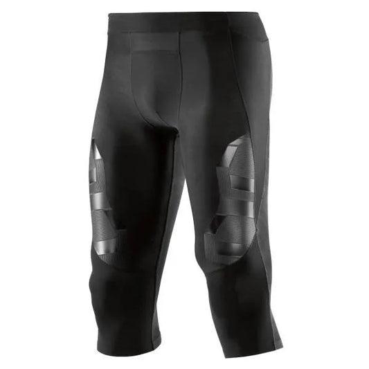 A male athlete wearing black Skins A400 3/4 compression tights, mid-stride during a workout.