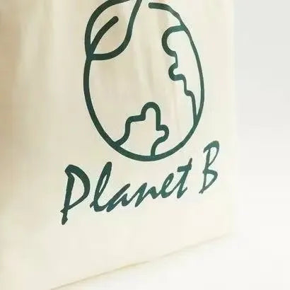 Gloo Planet B printed fold-up shopper bag made from sustainable materials. Bag is folded and displayed against a white background. Gloo Planet B eco-friendly shopper bag with colorful print, folded compactly on a white background. Perfect for reducing pla