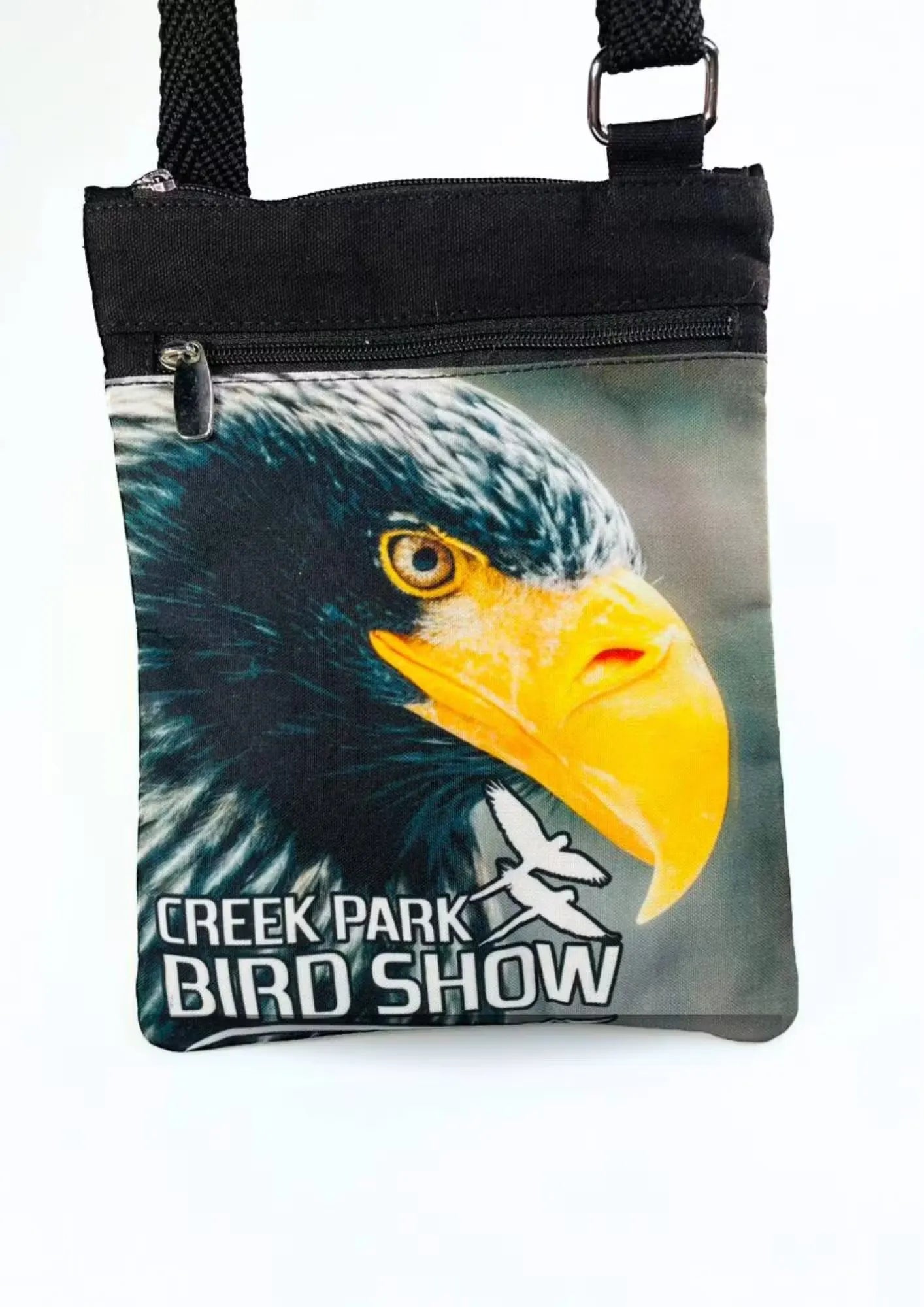A stylish Creek Park Bird Show side bag with a black exterior and cloths straps. The bag has multiple compartments and pockets for storing essentials.