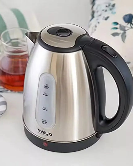 Insiya 1.8L electric kettle pouring water into a mug, highlighting its convenient spout and rapid boiling. Upgrade your kitchen with the stylish Insiya 1.8L electric kettle, featuring fast boiling and a premium design.
