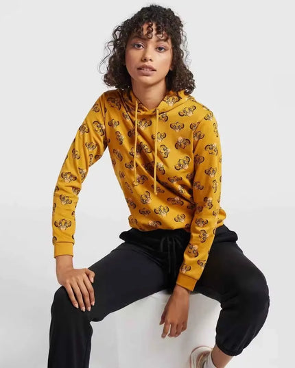 A woman wearing a hooded sweatshirt with a full-body print of The Lion King characters. Cozy up in style with the Max Lion King all-over print women's sweatshirt! Featuring a playful design and comfortable hoodie, this sweatshirt is perfect for casual wear. Shop now on Dubailisit!