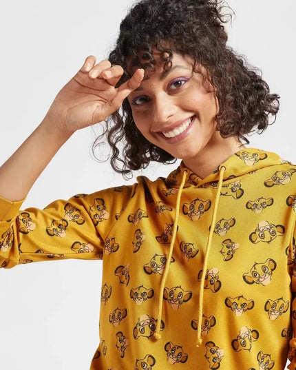 A woman wearing a hooded sweatshirt with a full-body print of The Lion King characters. Cozy up in style with the Max Lion King all-over print women's sweatshirt! Featuring a playful design and comfortable hoodie, this sweatshirt is perfect for casual wear. Shop now on Dubailisit!