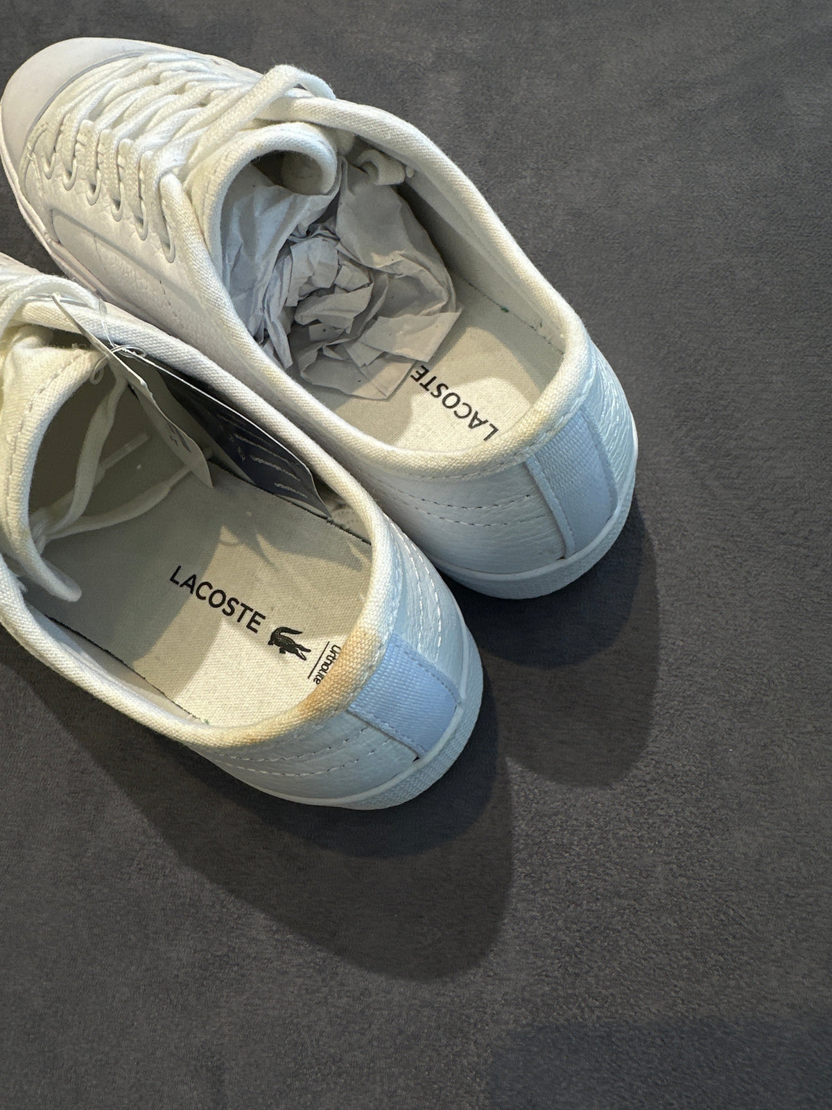 Lacoste white leather sneakers showing branded insoles