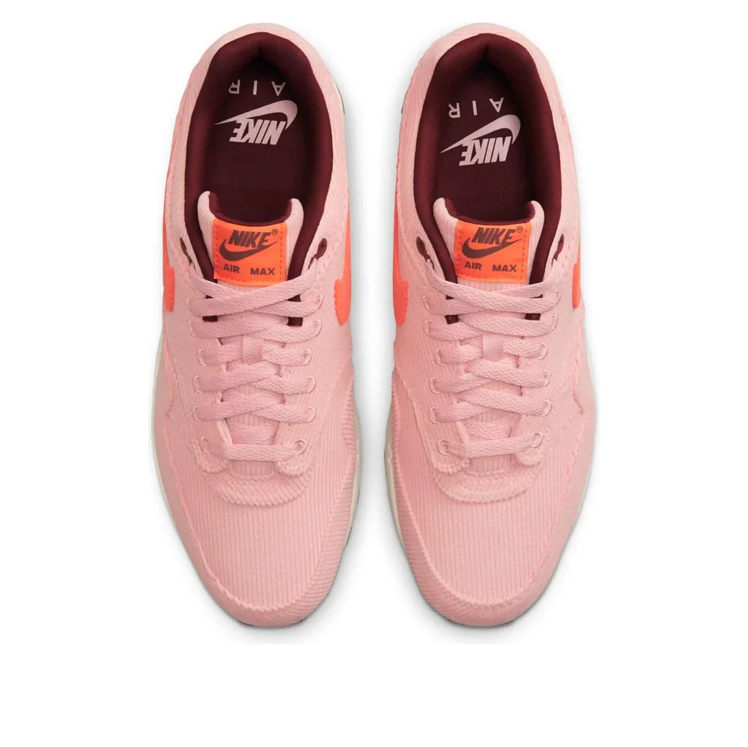 Pair of Nike Air Max 1 coral sneakers from above