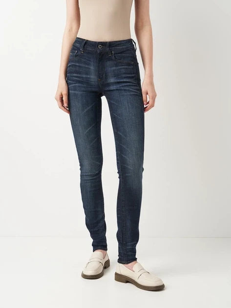 Front view of dark blue skinny fit jeans with a high waist on a white background