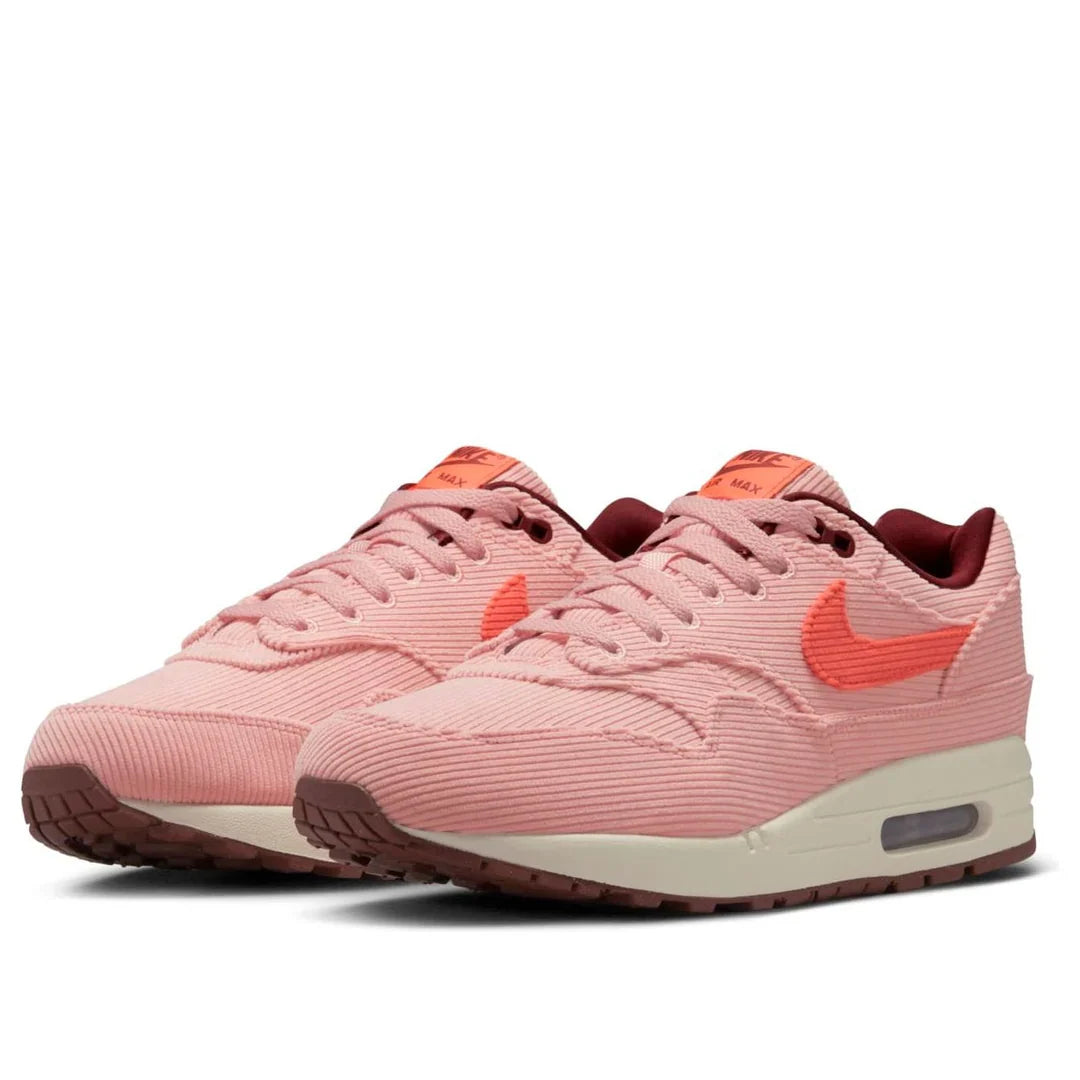 Pair of Nike Air Max 1 Coral Stardust sneakers, angled