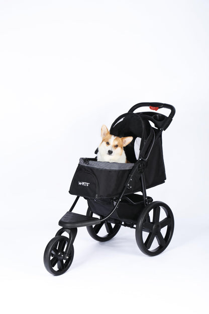 Small dog sitting in M-Pets Aventura black dog stroller, angled view