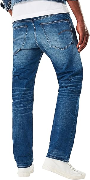 Back view of blue jeans showcasing pocket details and a faded design on a white background.