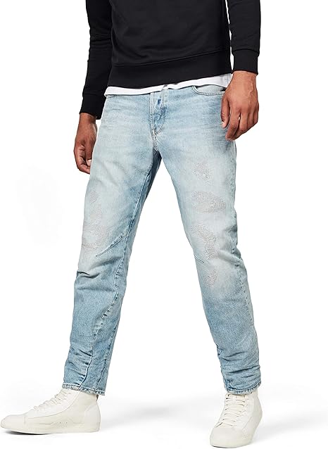 Lifestyle shot of light blue jeans featuring a faded design and distressed details against a white background.