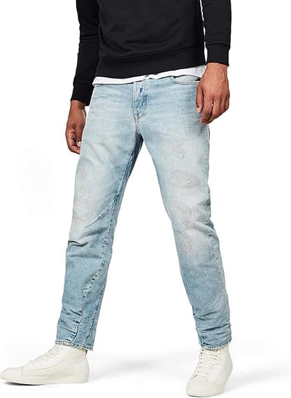 Lifestyle shot of light blue jeans featuring a faded design and distressed details against a white background.