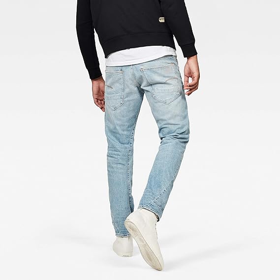 Back view of light blue jeans showcasing a slim fit and faded design on a white background.