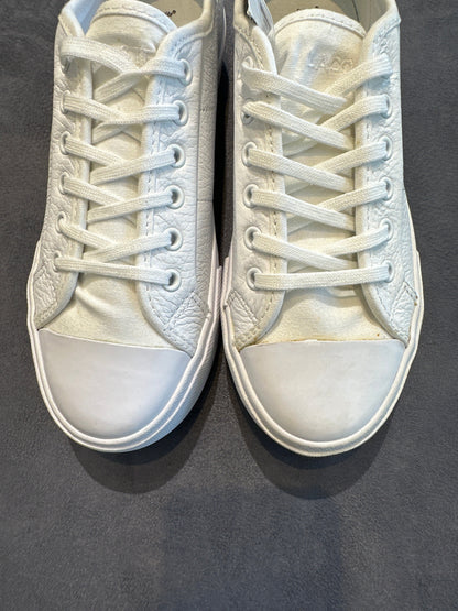 Close-up of Lacoste white leather sneaker toes and laces