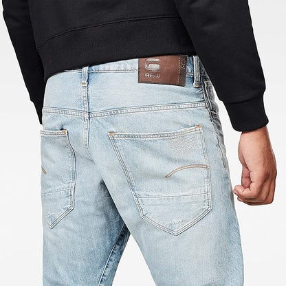Back view highlighting the back pockets and brand label of light blue jeans on a white background.