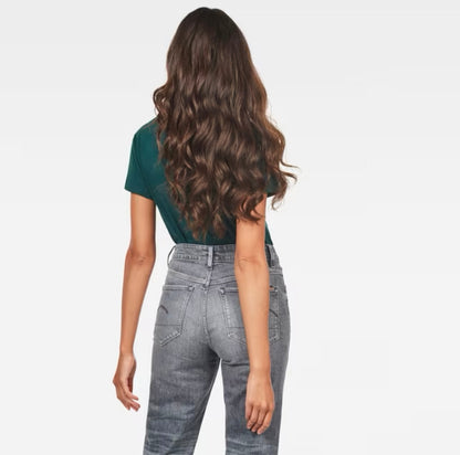 Back view of model with long hair in green G-Star Raw T-shirt and grey jeans