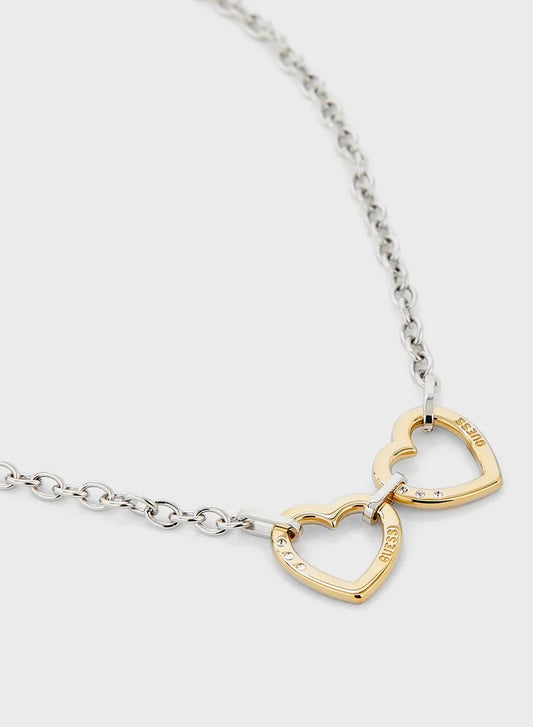 Close-up of gold two hearts pendant on silver Guess chain necklace