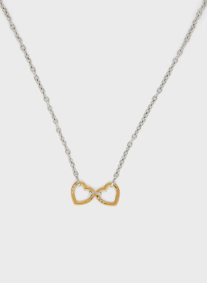 Guess two hearts necklace in silver and gold, hanging front view
