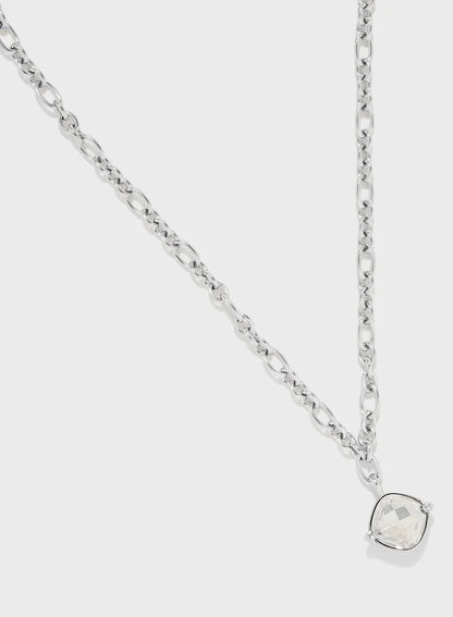 Close-up of square crystal stone pendant on silver Guess chain