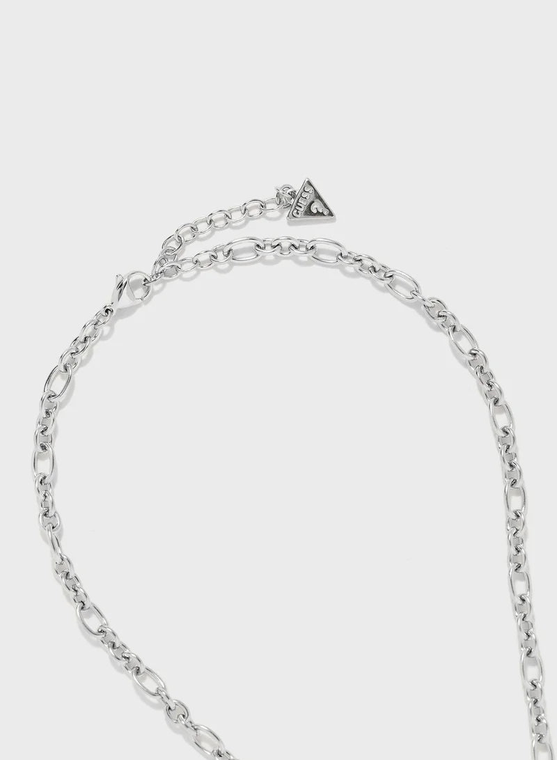 Close-up of silver chain links and triangle logo charm on Guess necklace