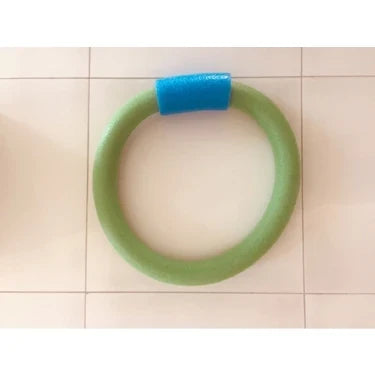 Green foam pool noodle ring with blue connector on a tiled floor
