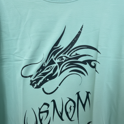 Close-up of black dragon and Venom lettering print on mint green t-shirt