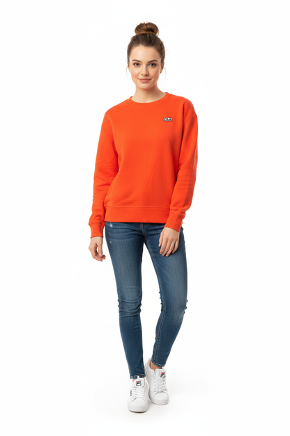 Woman wearing Fila orange sweatshirt with jeans