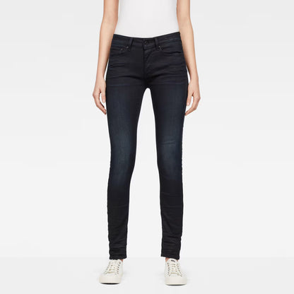 Front view of dark blue skinny jeans featuring a five-pocket design.