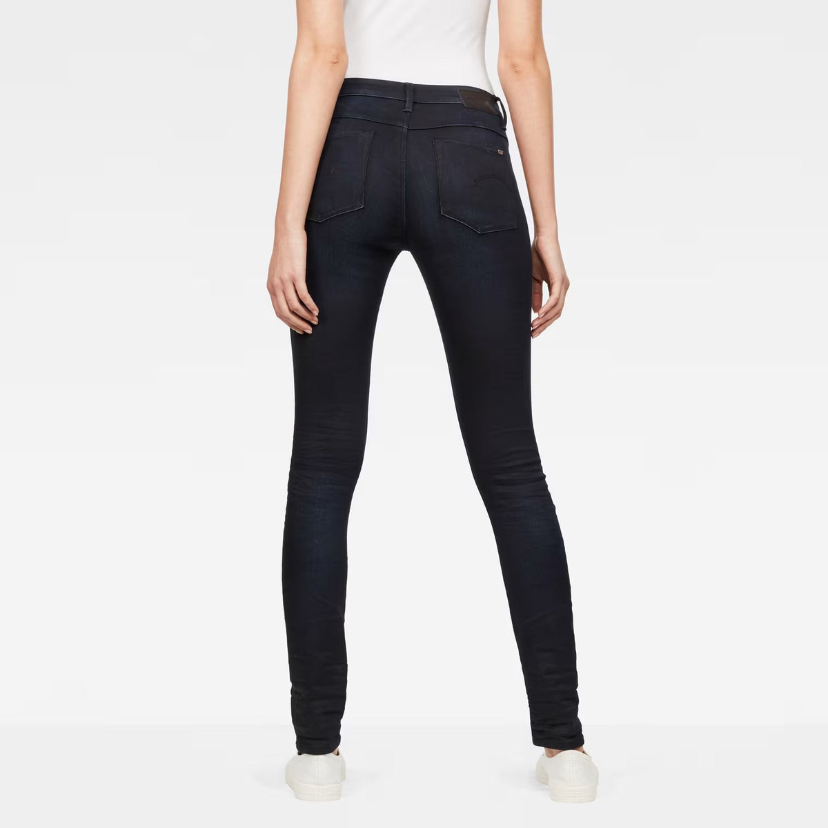Back view of dark blue skinny jeans with a high waist design.