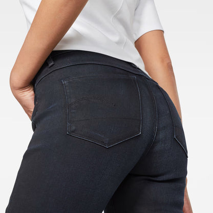 Close-up detail of dark blue skinny jeans showcasing back pocket and stitching.