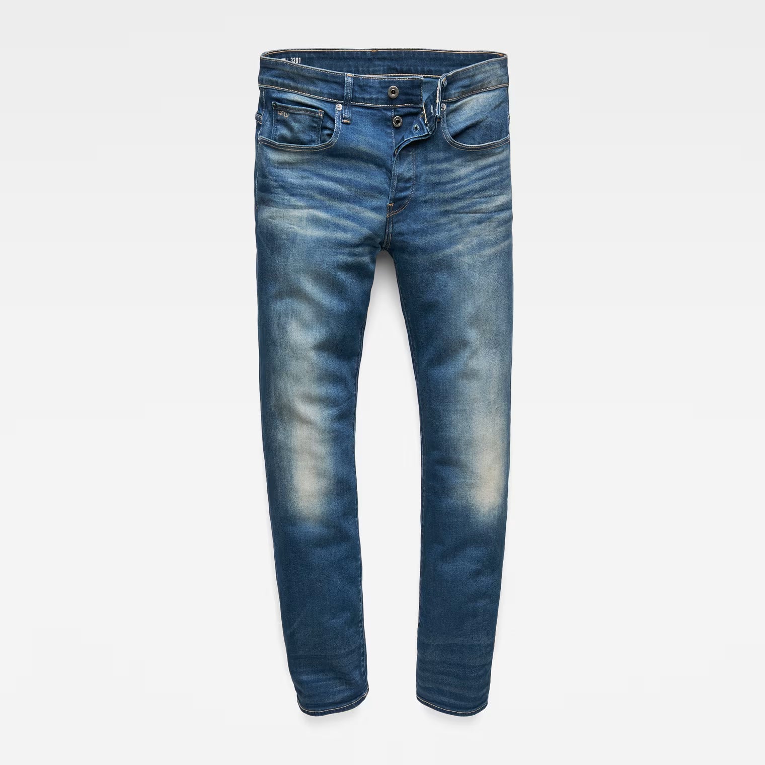 Front view of medium blue jeans with a straight fit and distressed details displayed on a white background.
