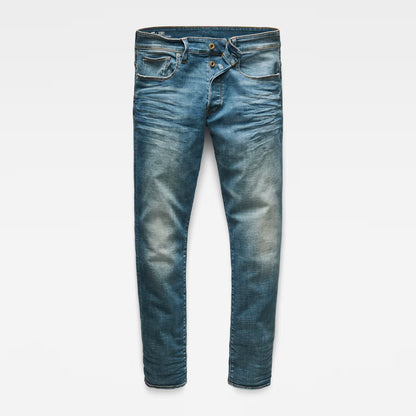 Front view of medium blue straight tapered jeans with distressed details on a white background