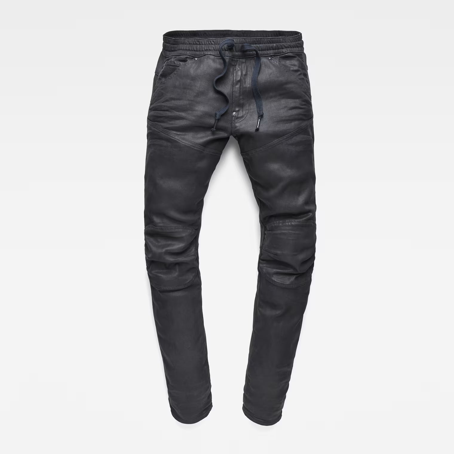 Detail view of the flat front of grey tapered jeans featuring a 3D design on a white background.