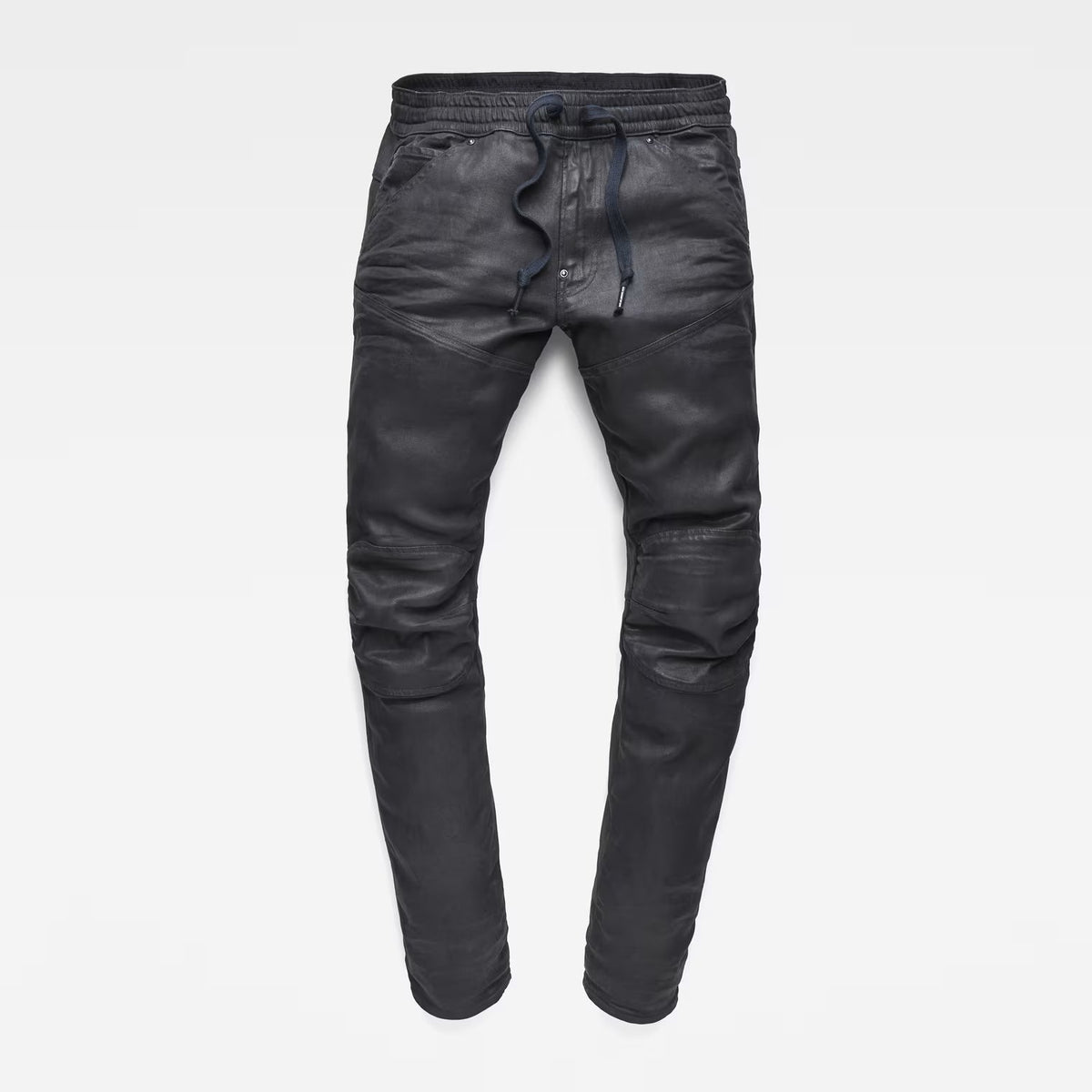 Detail view of the flat front of grey tapered jeans featuring a 3D design on a white background.