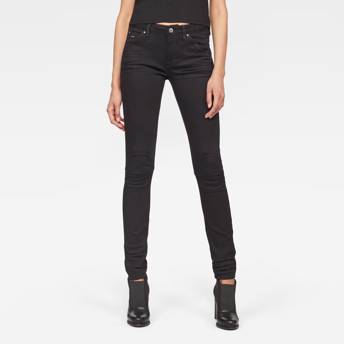 Front view of black skinny jeans with mid waist and skinny fit on a white background