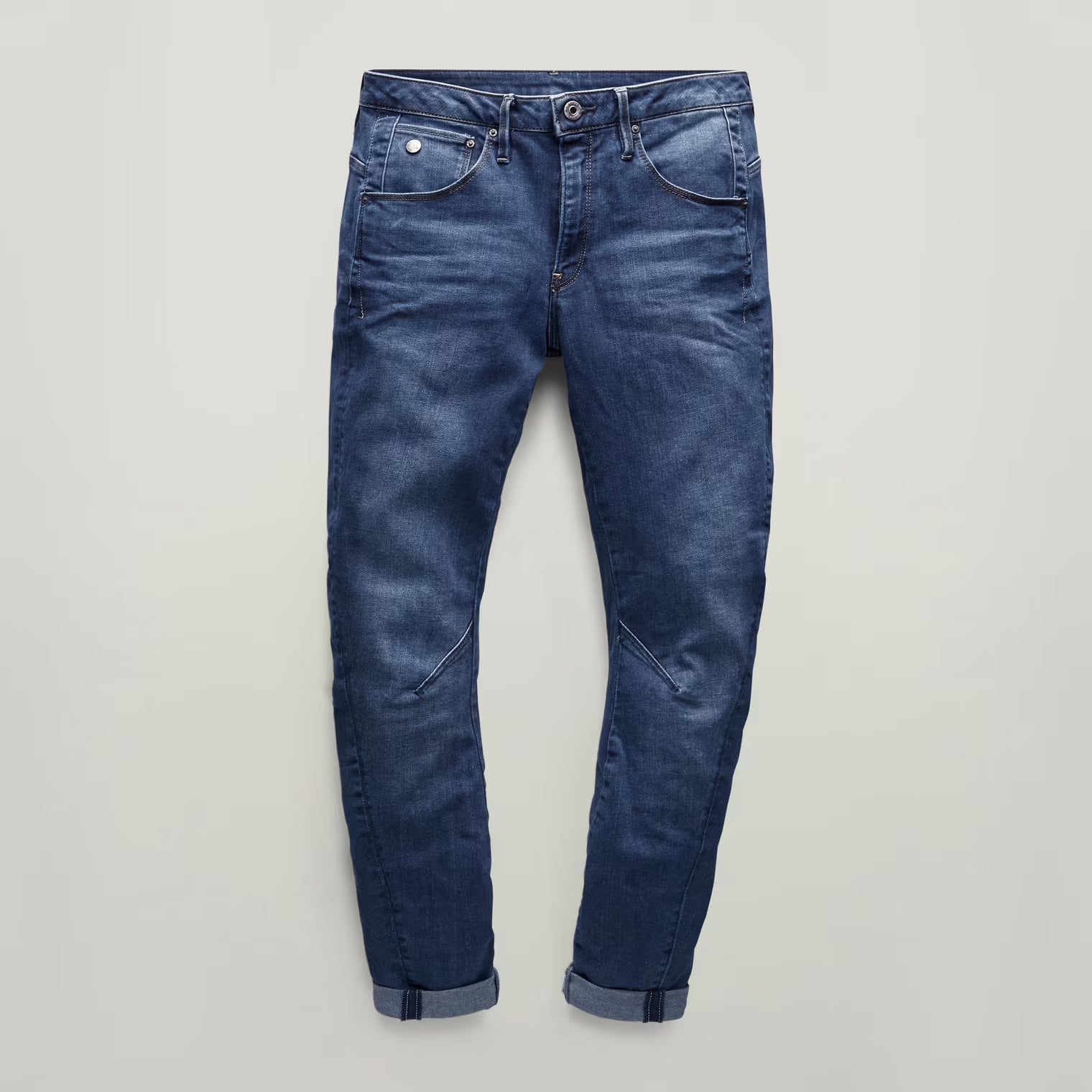 Other angle view of dark blue boyfriend jeans highlighting the distressed look from the front.