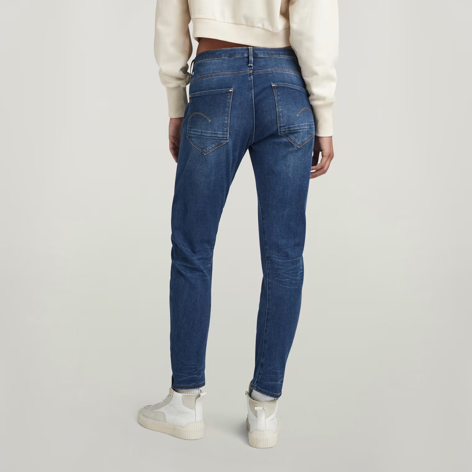 Back view of dark blue boyfriend jeans with a low waist and skinny fit.