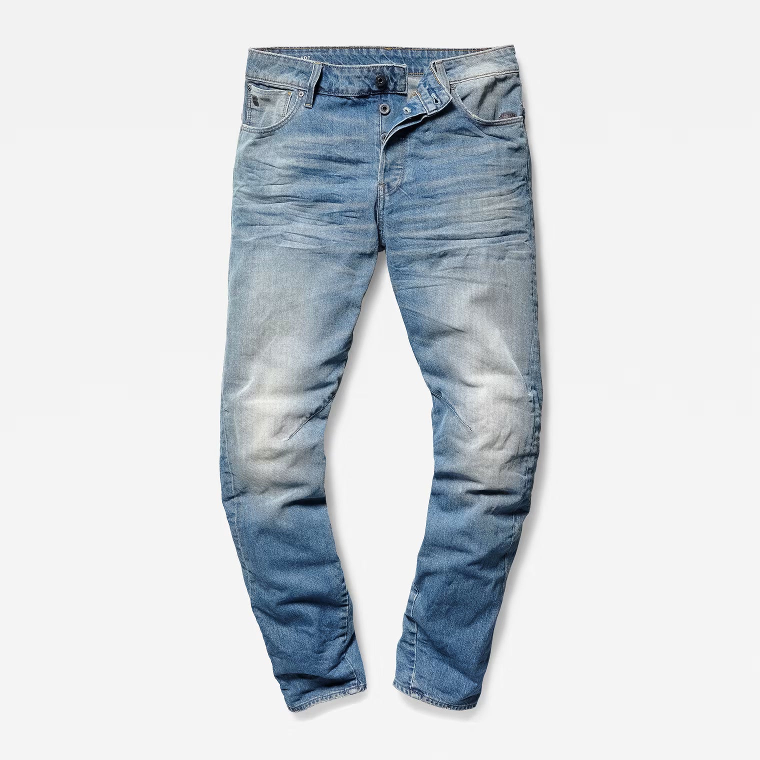 Front view of light blue denim pants featuring a relaxed fit and tapered leg on a white background.