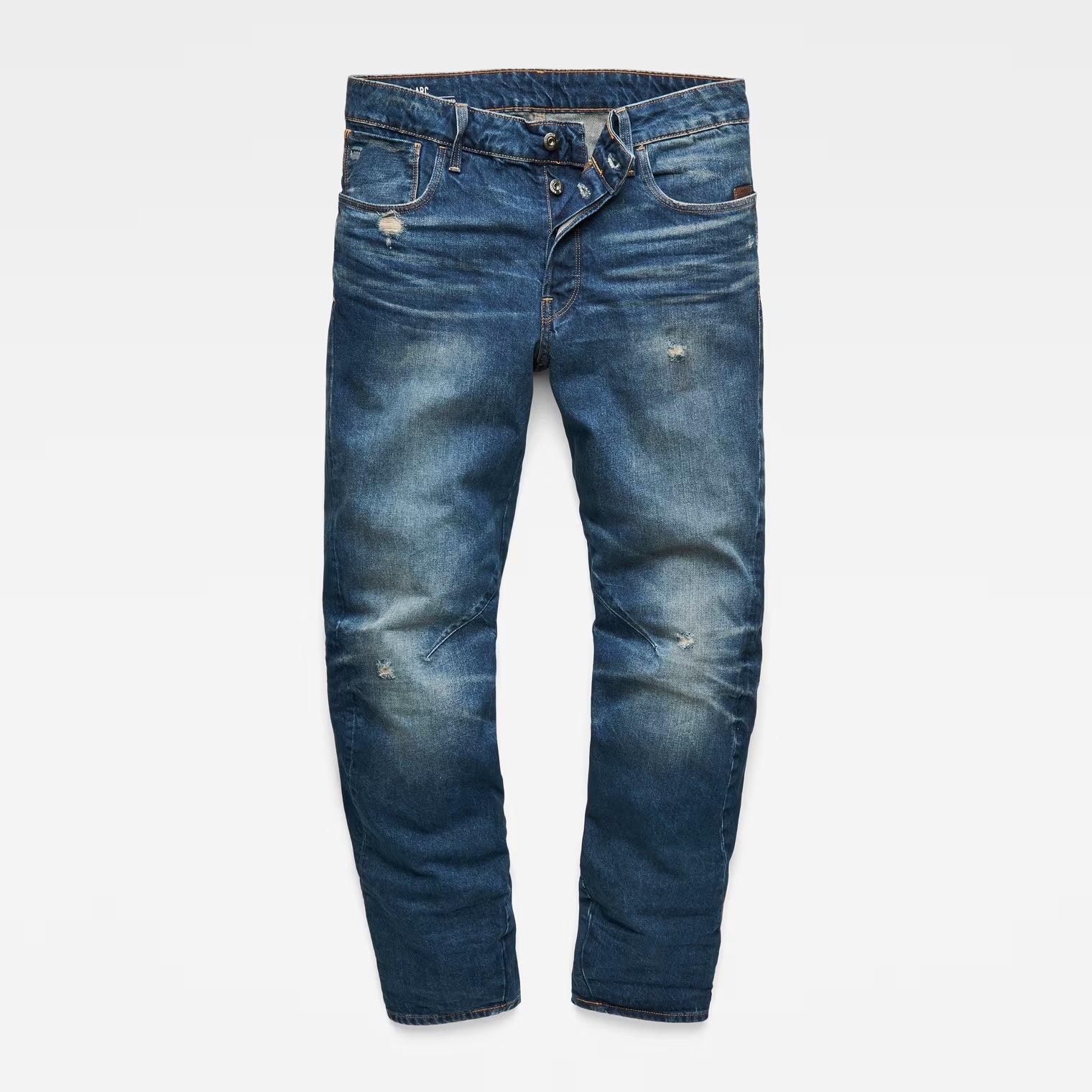 Front view of dark blue jeans with zipper fly and distressed details on a white background.
