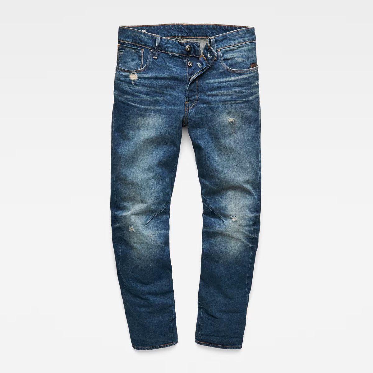 Front view of dark blue jeans with zipper fly and distressed details on a white background.