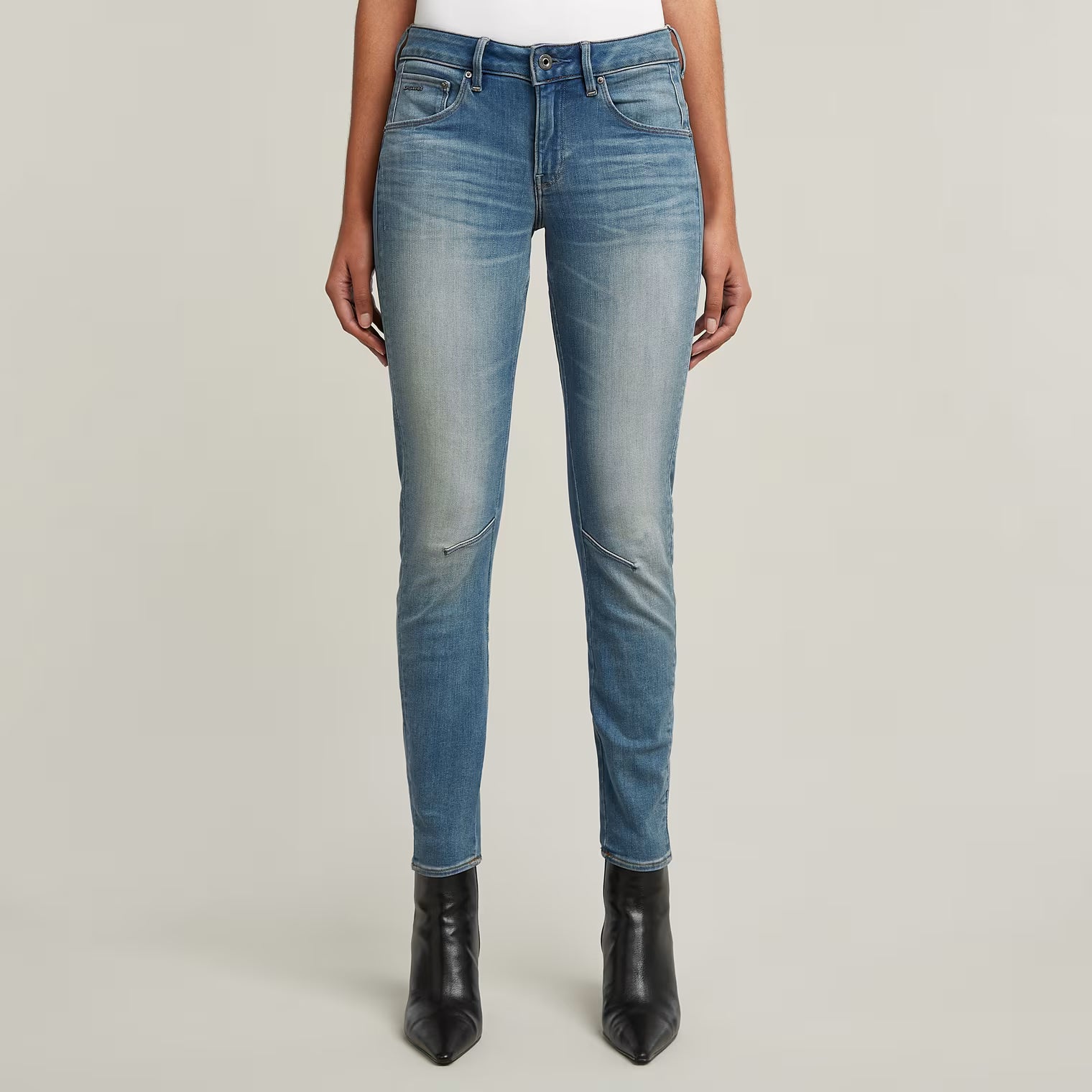 Front view of blue skinny jeans featuring a faded design and slim fit.