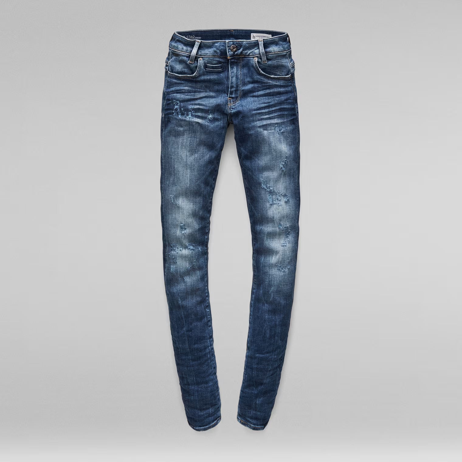 Front view of medium blue skinny jeans with a mid waist and skinny fit.