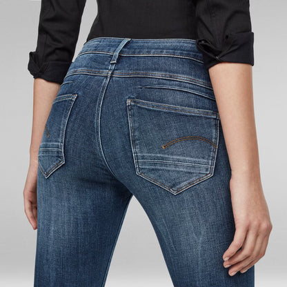 Detail shot of medium blue skinny jeans showing back pockets.