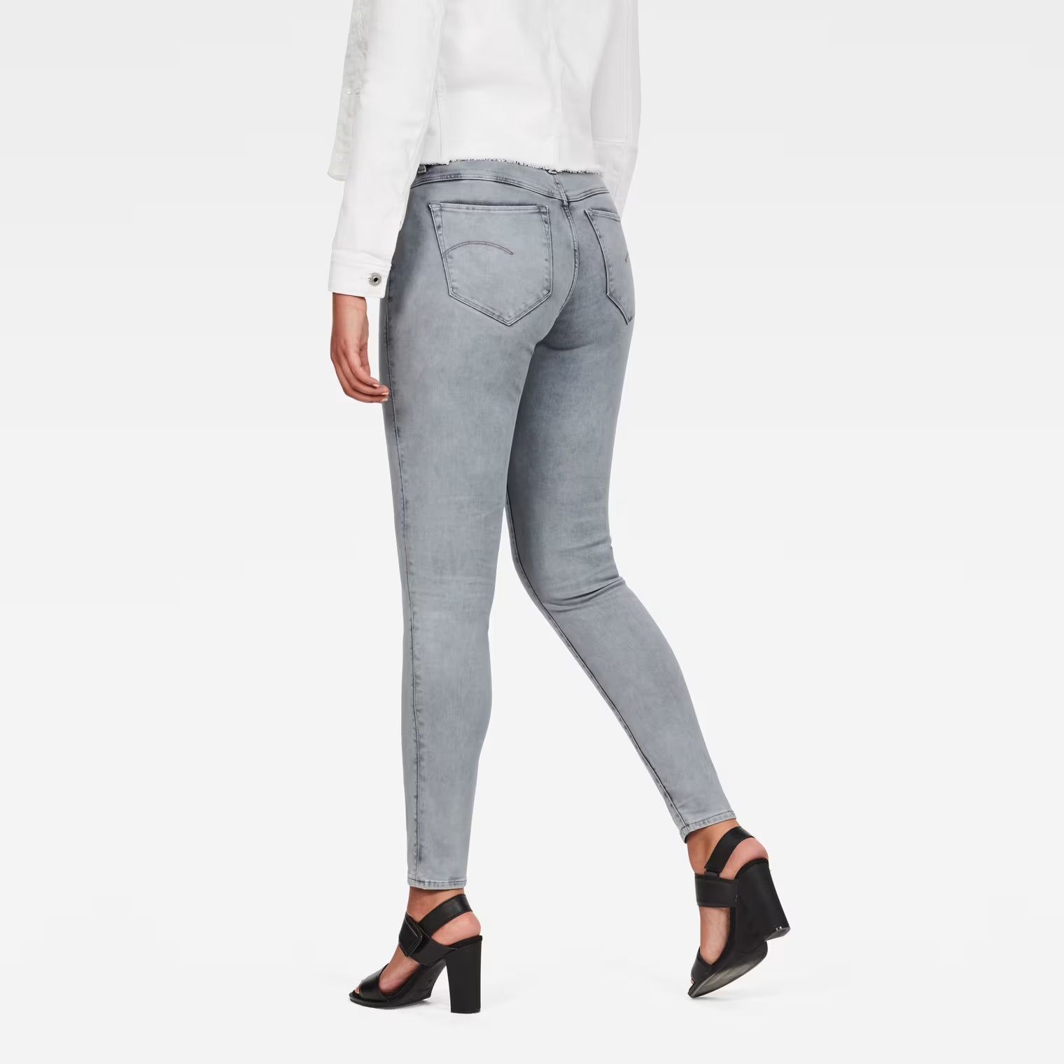 Back view of light blue skinny jeans showcasing the high waist and super skinny fit.