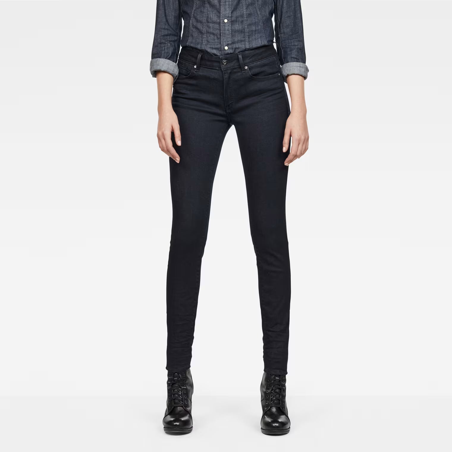 Front view of black skinny jeans featuring a super skinny fit and high waist on a white background.