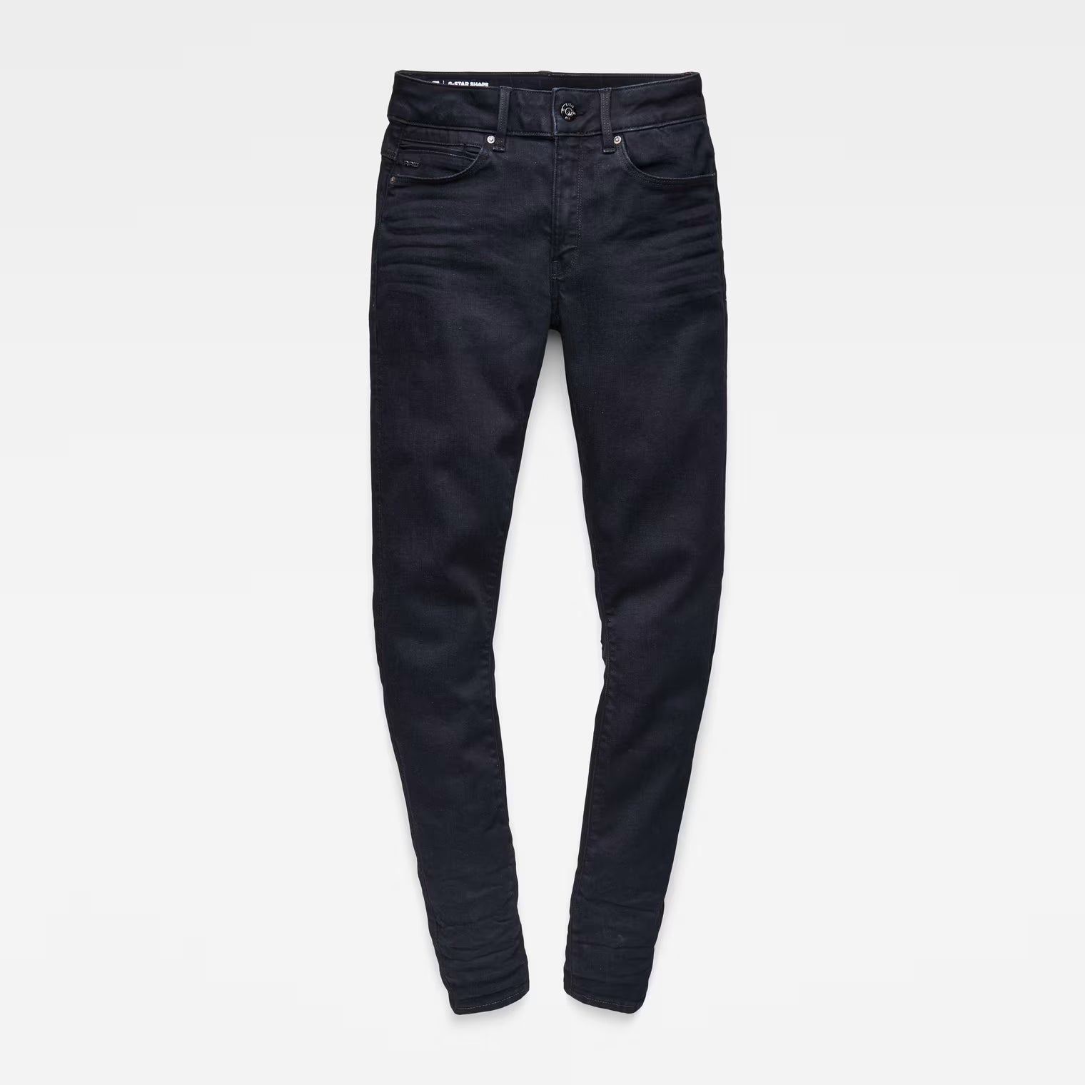 Flat lay of black skinny jeans with a high waist on a white background.