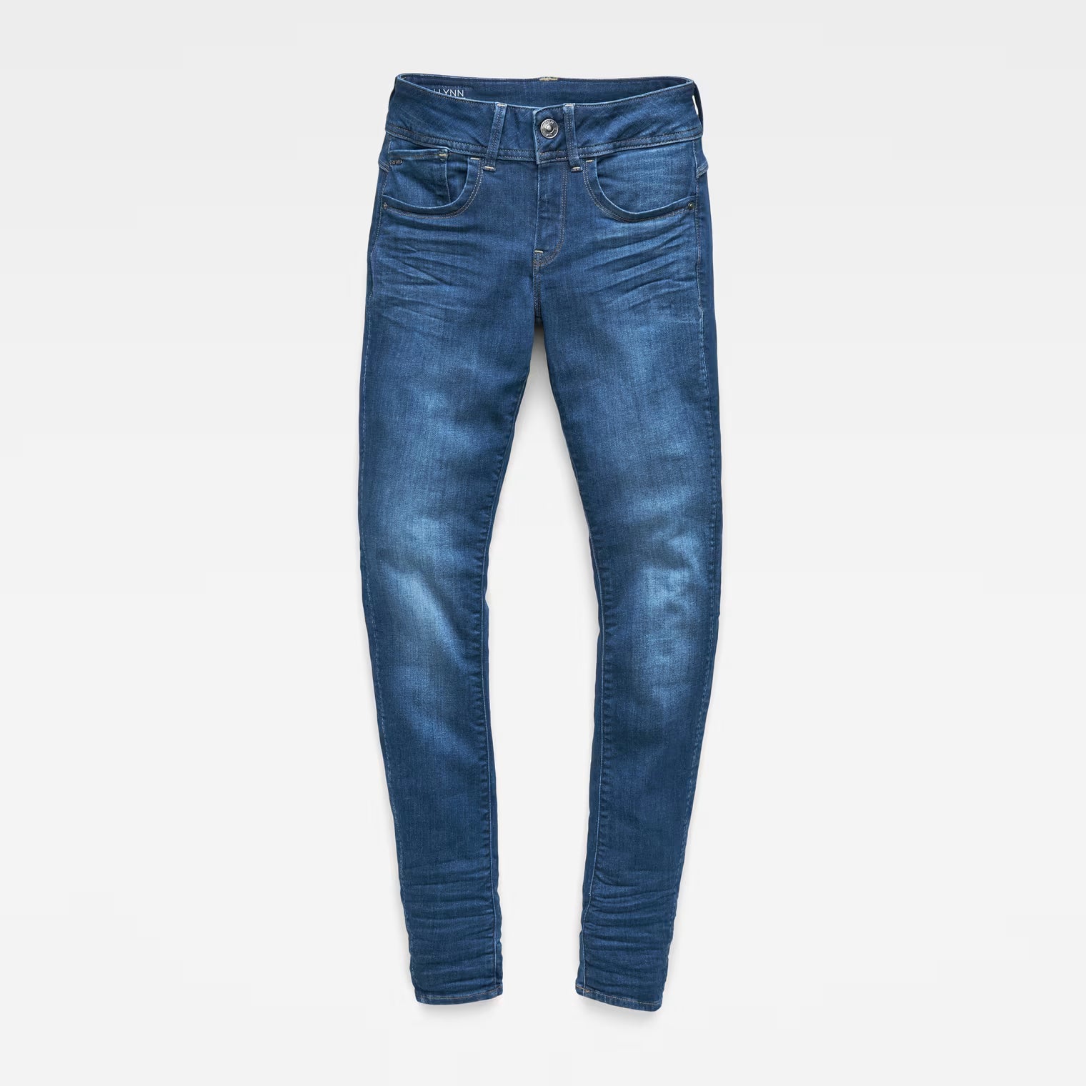 Front view of blue skinny jeans with mid waist on a white background